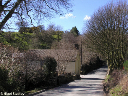 Picture of a house in a dip in the road