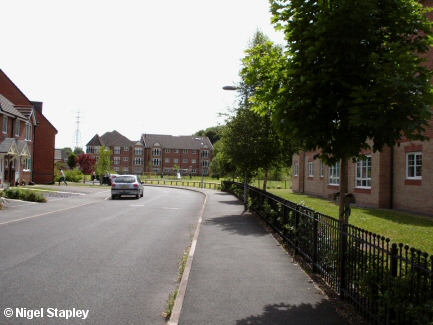 Picture of a road flanked by modern houses and apartments