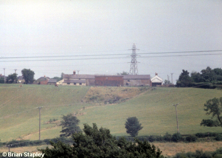 Picture of farm buildings from across a valley