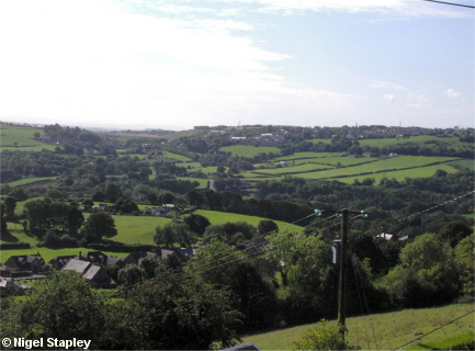 Picture of a village seen from across a deep valley