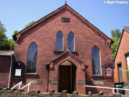 Picture of the front door of a red-brick chapel