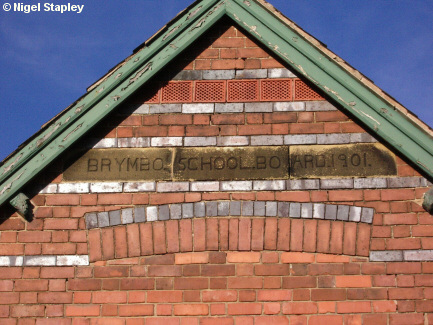 Picture of a stone set in the wall of a village school