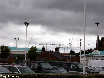 Picture of a shopping centre with cranes on the skyline in the background