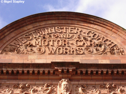 Picture of an inscription and carvings over a city centre library building