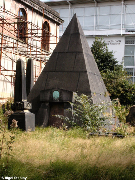 Picture of a pyramidal tomb in a derelict churchyard