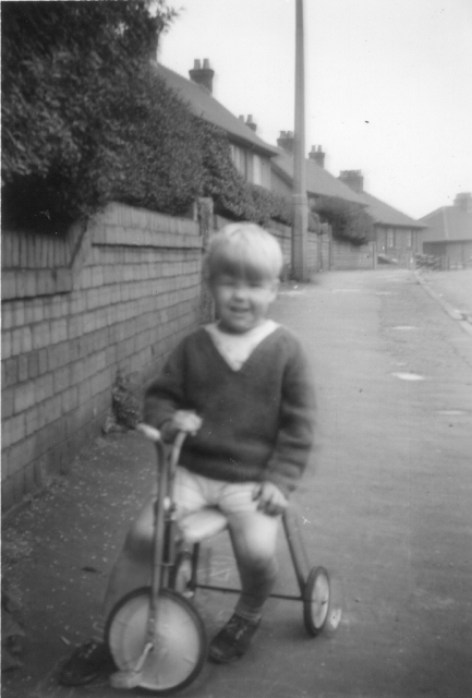 Picture of small boy on a small tricycle