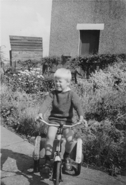Picture of boy riding a tricycle