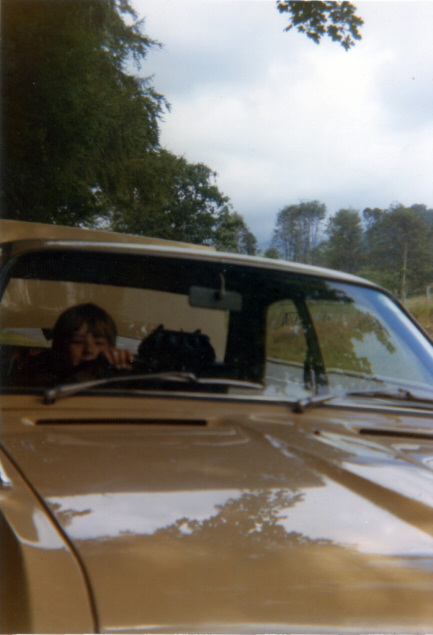 Photo of a boy at the wheel of a car