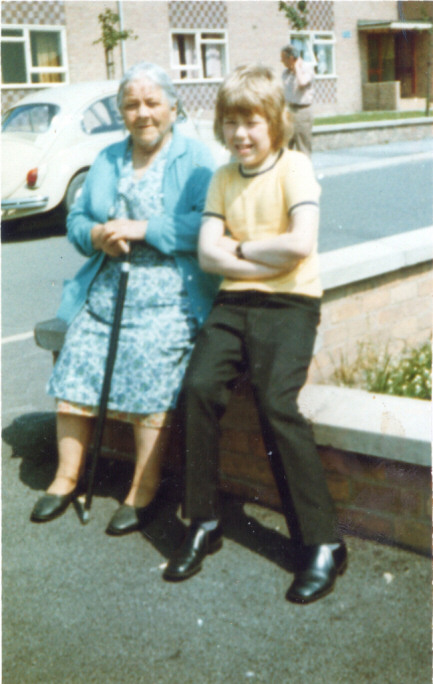 Picture of old woman and boy sitting on a wall