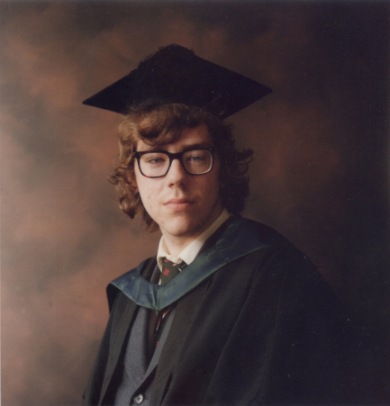 Photo of a man in graduation garb