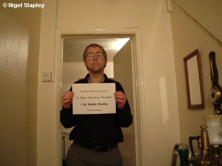 Photo of a man holding up a sign saying 'I Am Bradley Manning