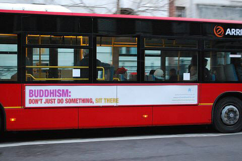 Bus sign saying 'Buddhism: Don't Just Do Something, Sit There'