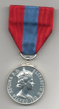 Photo of the obverse side of the Imperial Service Medal and its ribbon