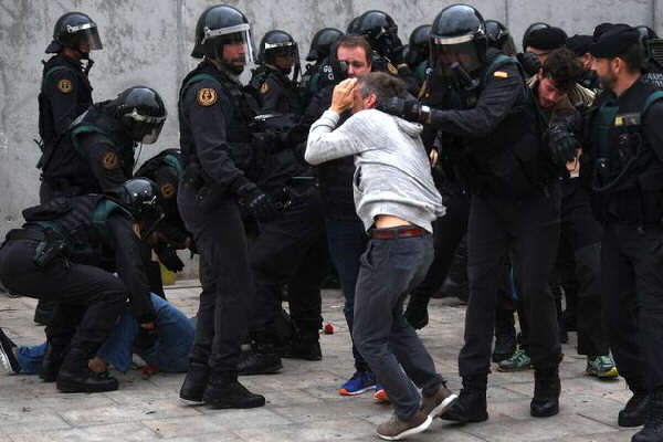 Photo of Spanish cops beating up a man