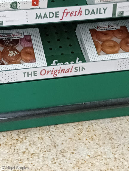 Photo of a display of doughnuts with the legend 'Original Sin...' on it