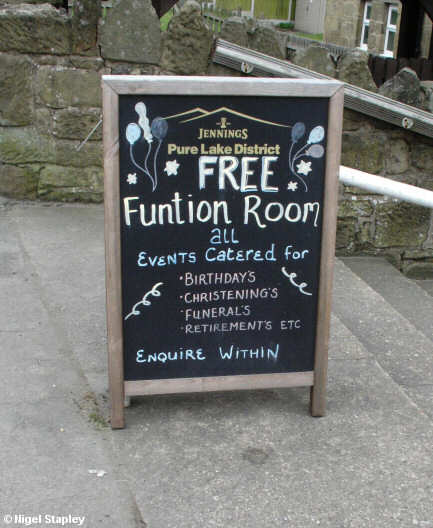 Signboard outside a pub advertising its 'Funtion Room'