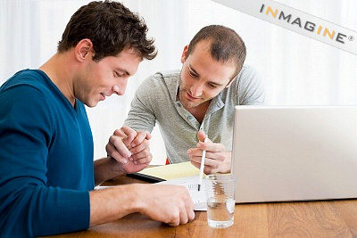 Picture of two men holding hands whilst they do the household accounts