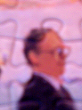Detail from a jigsaw showing a man in a black suit, side on