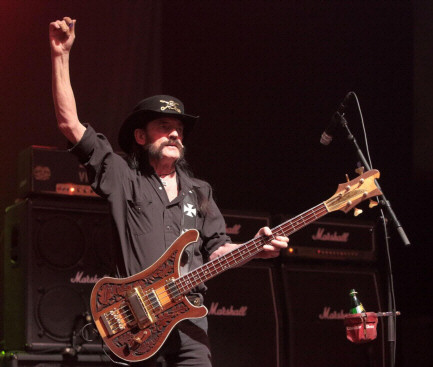 A photo of Lemmy in characteristic, on-stage pose