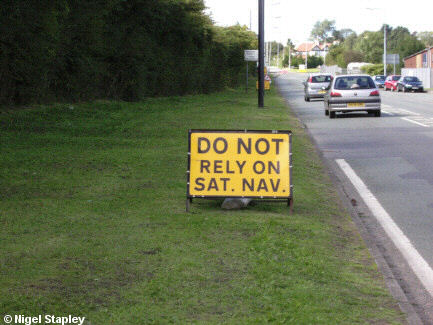 Road sign advising people not to depend on satnav