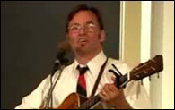 Picture of Roy Zimmerman singing and playing